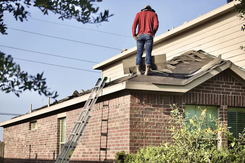 Professional roofer working on a residential roof in Southbury